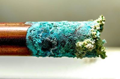 Corrosion build up on copper pipes due to acidic water in maryland